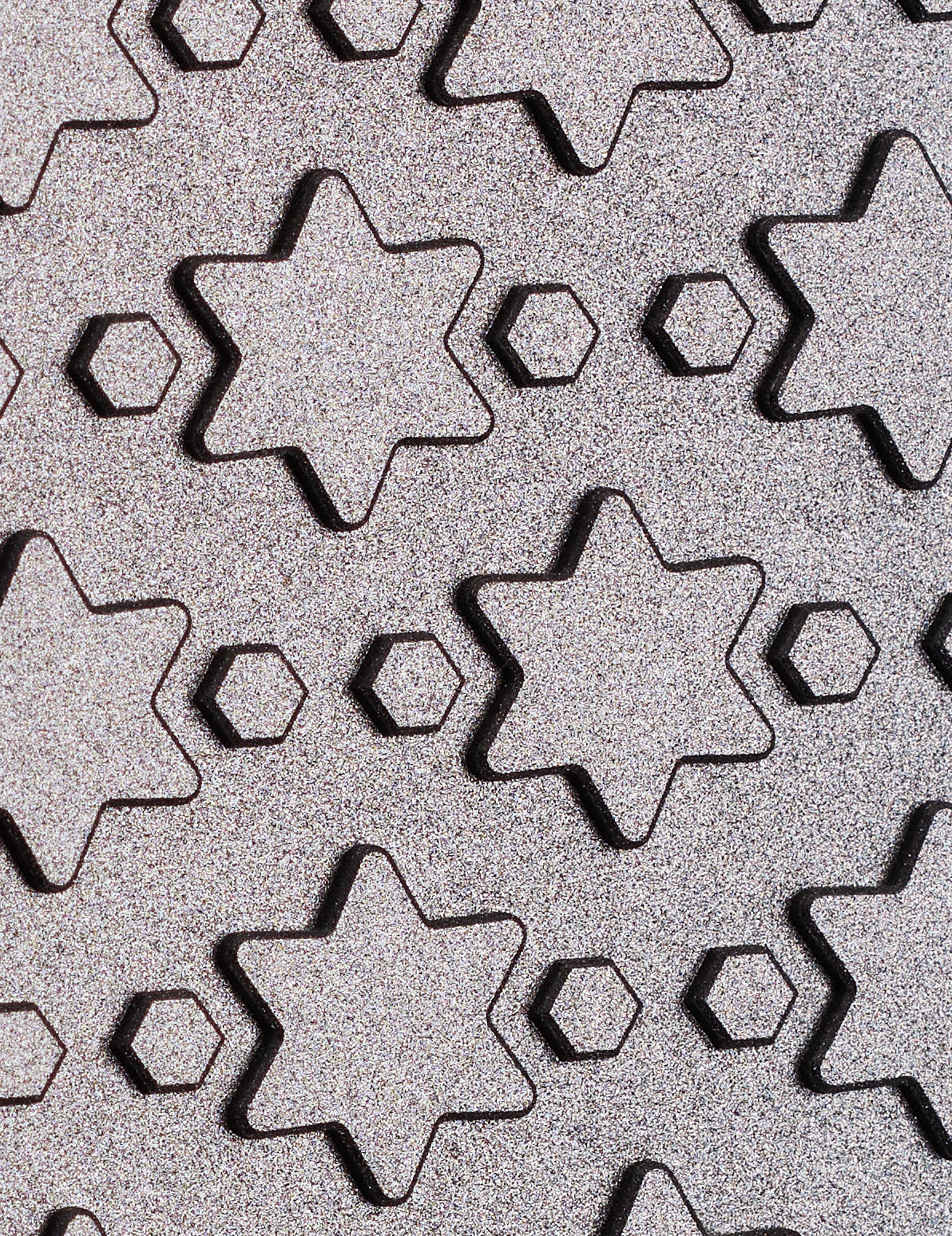 Zoomed in to reveal the diamond surface of a lapping plate with star and hexagonal pattern