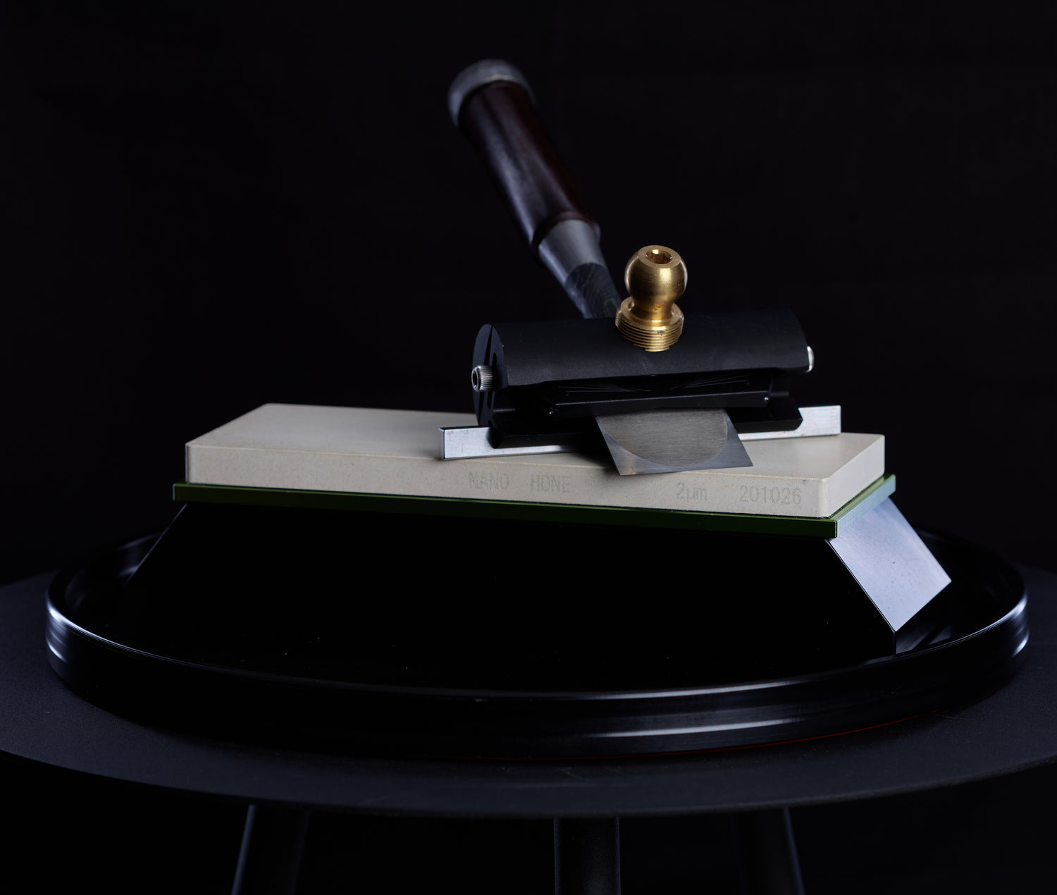 The Sharp Skate honing jig holds a chisel flat onto a sharpening stone to reveal how sharp the edge is